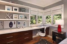 a bedroom with a bed, desk and shelves on the wall next to each other