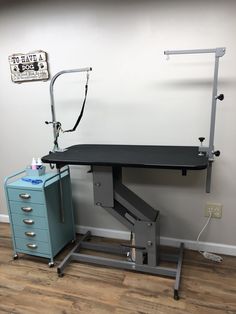 a desk with a lamp on it next to a filing cabinet