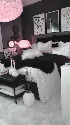 a black and white bedroom with pink accents