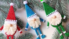 three christmas ornaments hanging from a pine tree