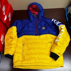 Polo Ralph Lauren Mens Blue Yellow 1/4th Zip Hooded Puffer Jacket Size Medium Brand: Polo Ralph Lauren Department: Men Size: M Color: Blue Yellow Type: Jacket Style: Puffer Jacket Theme: Classic Season: Winter, Fall Features: 1/4th Zip, Hooded Sleeve Length: Long Sleeve Condition: New With Tags I Offer Discounts For All Return Customers. - Jvs Yellow Hooded Winter Jacket With Pockets, Yellow Hooded Jacket With Pockets For Winter, Yellow Outdoor Outerwear With Detachable Hood, Yellow Hooded Jacket With Pockets For Streetwear, Blue Hooded Puffer Jacket For Hiking, Yellow Puffer Jacket With Pockets For Cold Weather, Yellow Hooded Jacket For Outdoor Activities, Yellow Hooded Puffer Jacket For Outdoor, Sporty Yellow Hooded Jacket For Outdoor