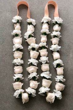 white flowers are arranged in the shape of letters