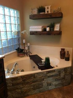 a bathroom with a stone bathtub and two shelves above the tub that have towels on it