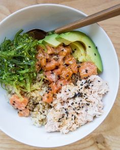 a white bowl filled with rice, meat and veggies