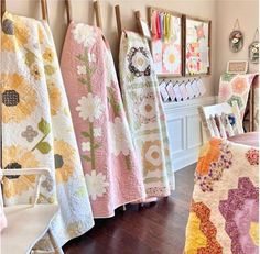 several quilts are lined up in a room