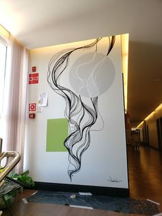 the wall is painted with black and white art on it's sides, along with a painting of a woman's hair