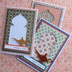 three cards with different designs on them and one has a bird, the other is a mosque