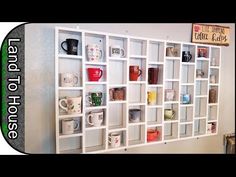 a white book shelf filled with cups and mugs