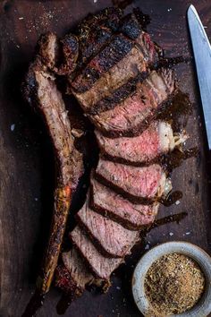 A sliced tomahawk steak on a cutting board with a bowl of seasoning. Steak Cooking Times, Porterhouse Steak Recipe, Grilled Porterhouse Steak, Tri Tip Steak, Tomahawk Steak Recipe, Steak Temperature, Cooking Tri Tip, Beef Tri Tip, Tomahawk Steak