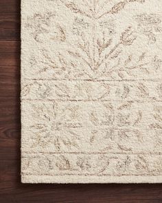 a white rug on top of a wooden floor