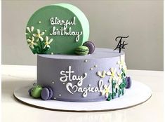 a birthday cake that is decorated with flowers and plants on the top, sitting on a plate