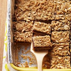 a pan filled with oatmeal bars on top of a wooden table