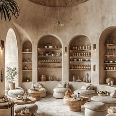 a living room filled with lots of furniture next to tall shelves covered in bottles and jars