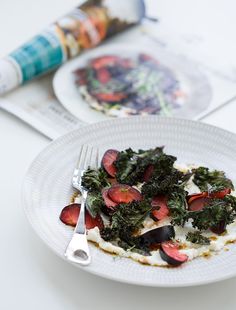 a white plate topped with food next to a fork