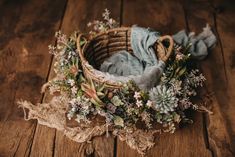 a basket filled with flowers on top of a wooden floor