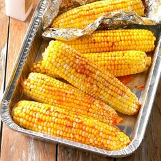 grilled corn on the cob in a pan with tin foil lined around it