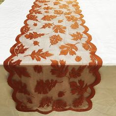 an orange table runner on top of a white table