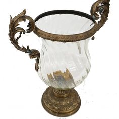 an ornate glass vase with gold trimmings