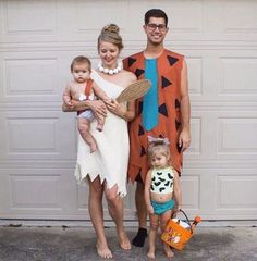 a man, woman and child are dressed up as the flintman and his wife