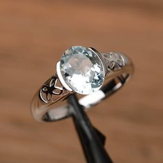 It is a natural aquamarine ring. The main stone is 7mm*9mm oval cut, weight about 1.58 carats.The basic metal is sterling silver and plated with rhodium.To change the metal to a solid gold (white/rose) or platinum is also available, please ask for a quotation if you want.You can also go to my shop Home for more elegant rings: https://www.etsy.com/shop/godjewelry?ref=hdr_shop_menuMore rings:https://www.etsy.com/shop/godjewelry?ref=l2-shop-header-avatarCustomization is always welcome and please fe Luxury Gold Birthstone Ring With Bezel Setting, Luxury Bezel Setting Birthstone Ring, Aquamarine Topaz Ring With Bezel Setting, Oval Aquamarine Topaz Ring With Bezel Setting, Silver Aquamarine Birthstone Ring, Oval Shape, Silver Aquamarine Oval Birthstone Ring, Silver Aquamarine Birthstone Ring, Oval Cut, Silver Oval Aquamarine Birthstone Ring, Silver Oval Aquamarine Ring