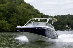 a man riding on the back of a boat while being pulled by a motorboat