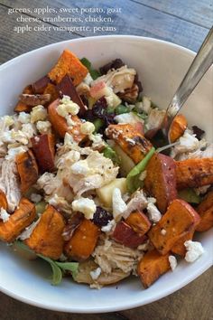 a white bowl filled with chicken and vegetables