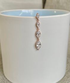 "This top-down belly button ring is the perfect amount of simple and beautiful. Made with surgical steel, this belly button ring dangles with four cubic zirconia marquise crystals, giving it a gorgeous sparkle, and making it practical for everyday wear. Drop jaws with this body jewelry. Silver Version: https://www.etsy.com/listing/959071198/marquise-crystal-silver-top-down-belly?ref=shop_home_active_2&frs=1&crt=1 Details & Size: ♥ Surgical Steel ♥ Cubic Zirconia Gems ♥ Nickel Free ♥ Top Down Belly Ring, Dangle Belly Rings For Wedding, Elegant Dangle Belly Rings For Wedding, Elegant Wedding Dangle Belly Rings, Belly Button Rings Dangle, Rose Gold Top, Ring Marquise, Belly Jewelry, Navel Ring