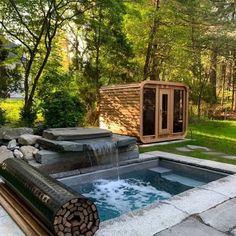 an outdoor hot tub in the middle of a yard