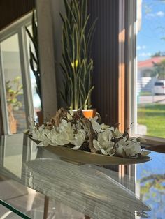 a glass table with white flowers on it