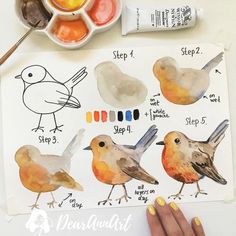 someone is painting birds with watercolors on paper