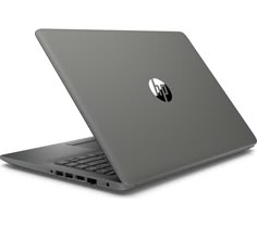 an open laptop computer sitting on top of a white surface with the hp logo on it