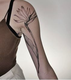 a woman's arm with a flower tattoo on the left side of her body