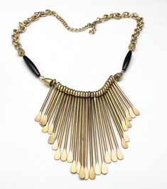 "Vintage Artisan Industrial Brass Pin Statement Necklace - Handmade artisan necklace made with brass chain, brass and black glossy beads - Pins are hammered flat on the bottom and are graduated length from 1.5\" to 3\" - 15.5\" to 18.5\" wearable length, lobster clasp - Total weight is 61.6g - Very good vintage condition, has not been cleaned The perfect necklace to go with your tribal/industrial look" Artisan Black Brass Necklaces, Black Brass Artisan Necklace, Artisan Black Brass Necklace, Black Brass Necklace For Festivals, Black Brass Necklace For Festival, Industrial Brass, Figural Jewelry, Artisan Necklace, Brass Pin