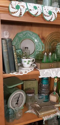 a book shelf filled with lots of books and knick - knacks on top of it