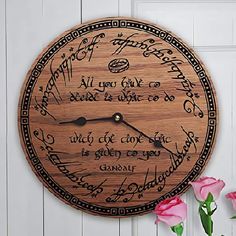 a wooden clock that has writing on it