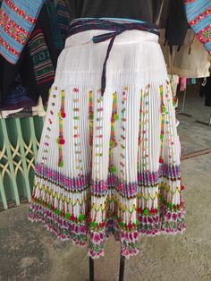 Hmong skirt vintage A remarkable women's skirt from northern Vietnam has been crafted using Vintage Hmong women's skirts. The original skirt, traditionally designed, was sewn using a combination of cotton and polyester materials. To enhance convenience and comfort, we make it with complete and elastic waistt. This allows customers to wear it with ease and enjoy optimal comfort. Measurements: Waist tie 65-96 cm Length 60 cm Please note that due to the handmade nature of these dresses, each piece Traditional Skirt With Woven Motifs, Traditional Long Skirt For Spring, Bohemian Skirt With Traditional Patterns For Festivals, Traditional White Festival Skirt, Festive Bohemian Skirt With Traditional Patterns, Traditional Skirt With Traditional Patterns For Festivals, Traditional Multicolor Skirt For Festival, Traditional White Skirt, Traditional Multicolor Skirt