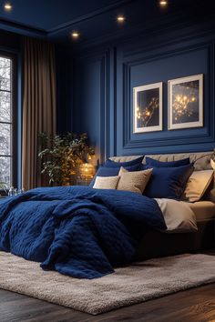 a bedroom with dark blue walls and white rugs on the floor is lit by candles