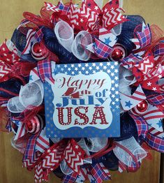 a wreath with the words happy 4th of july on it and red, white, and blue decorations