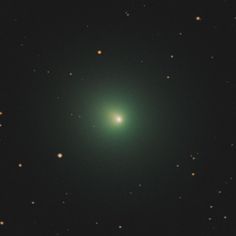 an image of a green object in the dark night sky with stars around it,