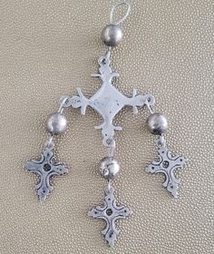 Beautiful large rustic Yalalag cross from the 50's acquired in Oaxaca. Cross is unmarked, but has tested as silver. Beads are base metal or copper with a silver wash. The minor markings or imperfections on the silver crosses only add to their amazing patina. Pendant alone is 4 1/2" long. With its looped bail and bead, it is 5 3/4" long.  It's main cross is 2 1/4" wide. With the inclusion of the smaller crosses, it is in total approximately 3" " wide. A truly amazing piece and clearly well-loved Bohemian Metal Cross Jewelry, Bohemian Cross Metal Jewelry, Silver Beaded Cross Jewelry, Artisan Silver Cross Jewelry, Artisan Silver Cross Pendant Jewelry, Bohemian Silver Cross Pendant Jewelry, Traditional Silver Cross Necklace, Vintage Silver Cross Pendant Jewelry, Silver Hand Forged Cross Pendant Jewelry