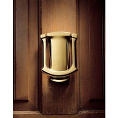 a gold door handle on a wooden door