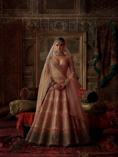 a woman in a bridal gown posing for the camera