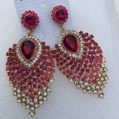 Glamorous Pink Jewelry For Celebration, Glamorous Pink Dangle Jewelry, Pink Rhinestone Drop Earrings, Glamorous Pink Earrings For Celebration, Pink Drop Earrings With Rhinestones, Pink Rhinestone Chandelier Earrings For Party, Pink Chandelier Earrings With Rhinestones For Party, Pink Party Chandelier Earrings With Rhinestones, Pink Jeweled Crystal Earrings