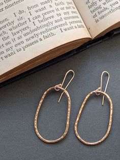 Gold asymmetrical hoop earrings - Gold hoop earrings with gold earhooks. * 14ct Gold Filled (rolled gold- with a brass core) - with gold filled hooks What is 'Gold Filled?'A brass core with a 14ct gold coating. The gold is bonded to the brass core surface using heat and pressure meaning it will never come off, wear away or flake! It is not the same as 'gold plating' but instead is a solid layer of 14ct gold which is approx. 100x thicker than gold plating. Meaning you get the beauty of wearing gold without the hefty price tag! Dimensions-  Hoop size approx 3.7cm by 2.2cm across  Approx 5.2cm total drop. Will arrived gift wrapped in a luxury gift box. With a subtle hammered shimmer that reminds me of the sun glistening of the surface of the sea. Elegant everyday jewellery with a classic time Minimalist Oval Single Earring, Minimalist Single Oval Earring, Everyday Yellow Gold Oval Link Earrings, Yellow Gold Oblong Earrings For Everyday, 14k Gold Oval Link Earrings For Everyday Wear, Gold Minimalist Oval Link Earrings, 14k Gold Oval Earrings For Everyday, Minimalist 14k Gold Oval Link Earrings, Everyday 14k Gold Oval Link Earrings