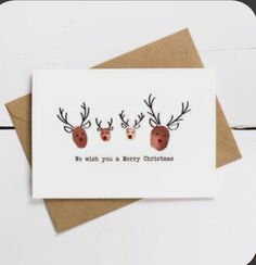 three reindeer heads with antlers on them are shown in this card