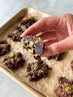 a person is holding up some cookies in their hand and it looks like they are made out of chocolate