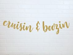 a white brick wall with gold foil lettering that says, cruisin & boogin