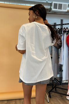 Also available in White with Red Bow. Product Deets White with black bow tee 100% cotton Boxy, oversized fit Bow graphics on chest Size small measures 22” in front, 24.5” in back Runs true to size Model Info Erielle is 5’1. Waist: 24" Bust: 32A Wearing size Small. Oversized Summer T-shirt, Chic Cotton T-shirt With Graphic Print, Chic Cotton Crew Neck T-shirt, Crew Neck Tops For Day Out, Oversized White T-shirt For Day Out, White Oversized T-shirt For Day Out, Chic Boxy Fit Crew Neck Top, Cotton Graphic Print Top For Day Out, Cotton Crew Neck Top For Day Out