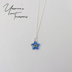 This beautiful Forget Me Not flower is made with a real pressed and dried forget me not flower and UV resin accompanied with an 18 inch/45 cm  Sterling Silver chain. Each flower is unique and measure approximately 1 cm/10mm in diameter. This lovely piece will be shipped in a small gift box. Matching earrings can be found here : https://www.etsy.com/uk/listing/1111963841/handmade-hypoallergenic-forget-me-not?click_key=763d5bf805b67333cb737a9885c55444925d1dd2%3A1111963841&click_sum=f157a8f4&ref=sh Blue Sterling Silver Birth Flower Jewelry, Blue Sterling Silver Jewelry With Birth Flower, Blue Sterling Silver Necklace With Flower Charm, Sterling Silver Necklaces With Pressed Flowers, Silver Pressed Flowers Necklace, Silver Flower-shaped Necklace With Pressed Flowers, Forget Me Not Flower, Small Gift Boxes, Flower Earrings Studs