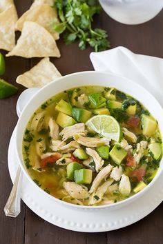 a white bowl filled with chicken and vegetable soup